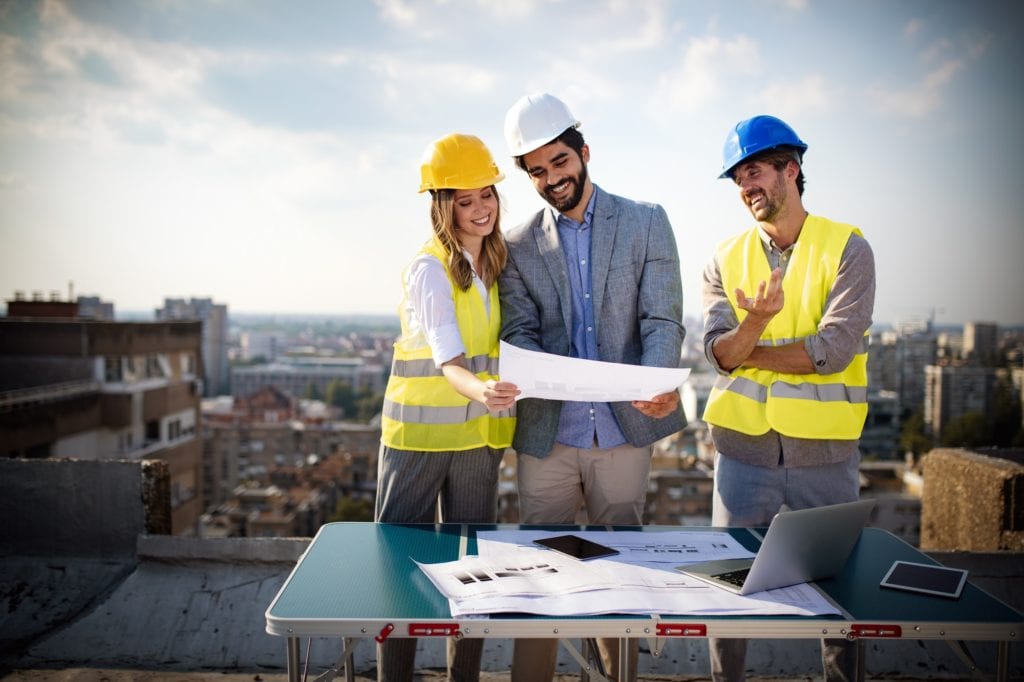 Architects, business manager and engineer meeting project at building site